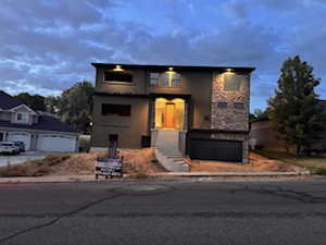 Contemporary two-story residence featuring a stone and stucco facade