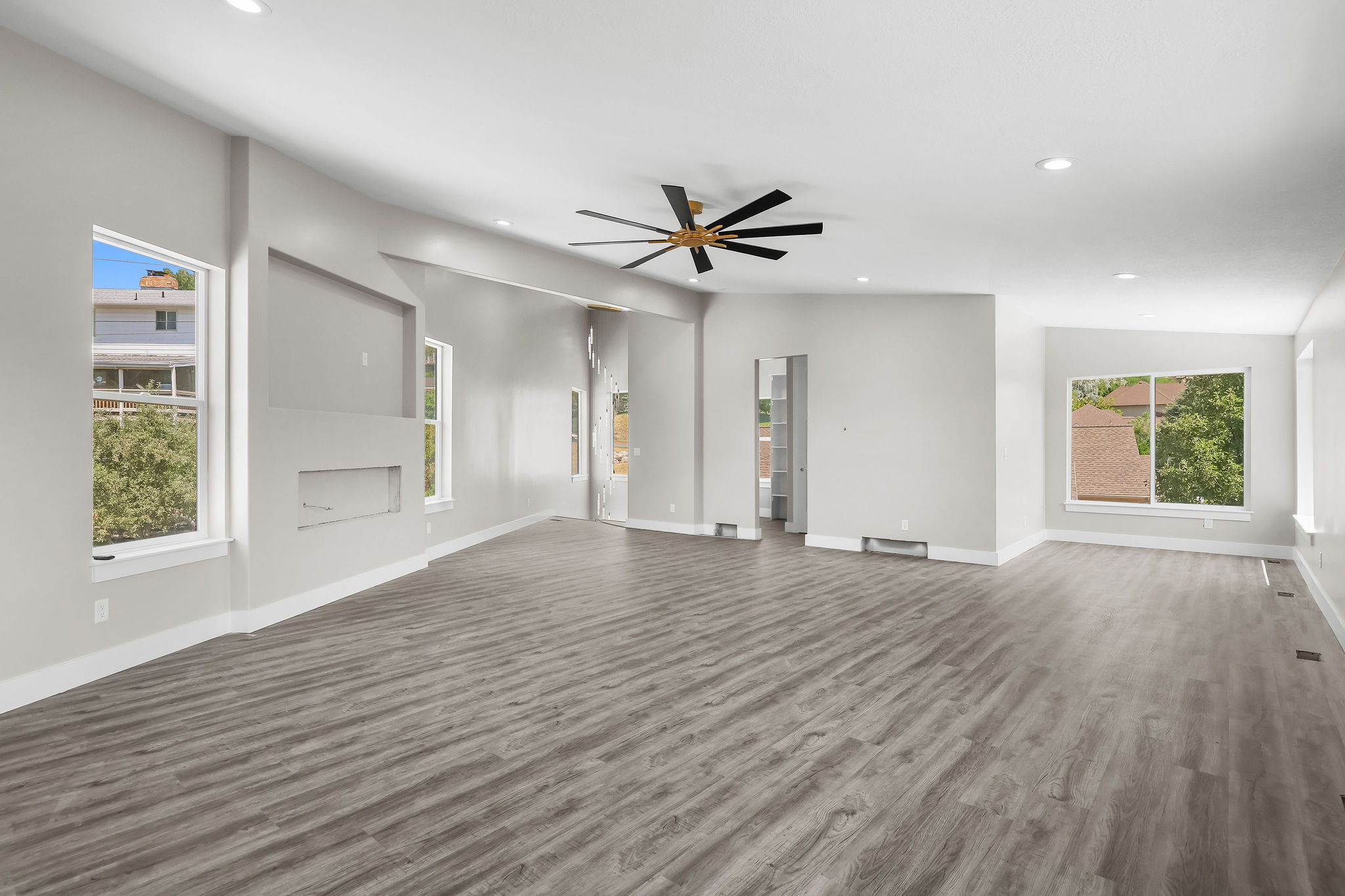Spacious PRIMARY SUITE,  featuring wood-finish flooring and recessed lighting