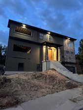 Contemporary exterior with stone facade accents and stucco finish