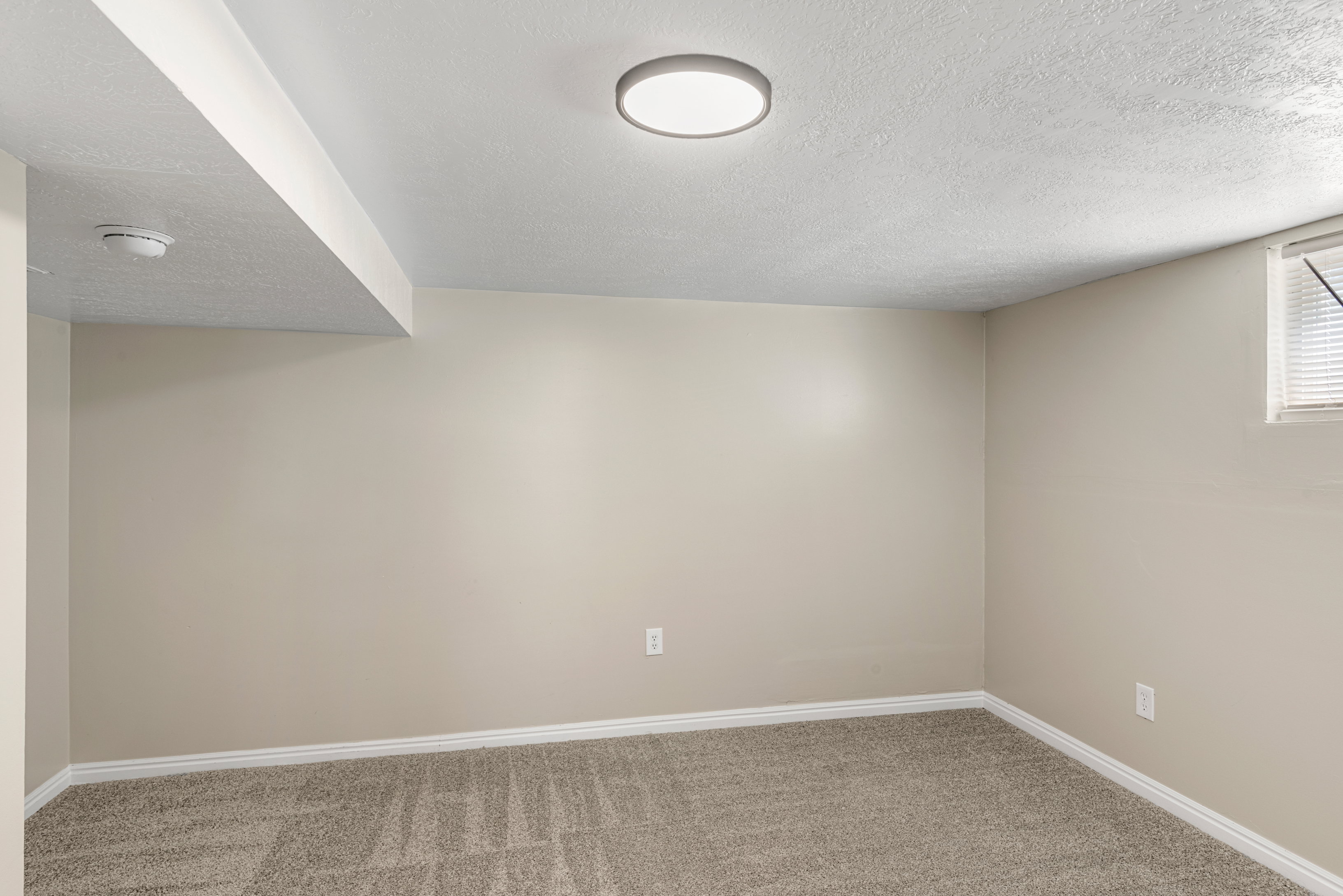 Basement bedroom with two-tone paint, LED lighting, and carpet flooring