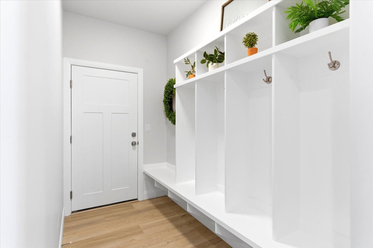 Entryway featuring wood-finish flooring and a white paneled door