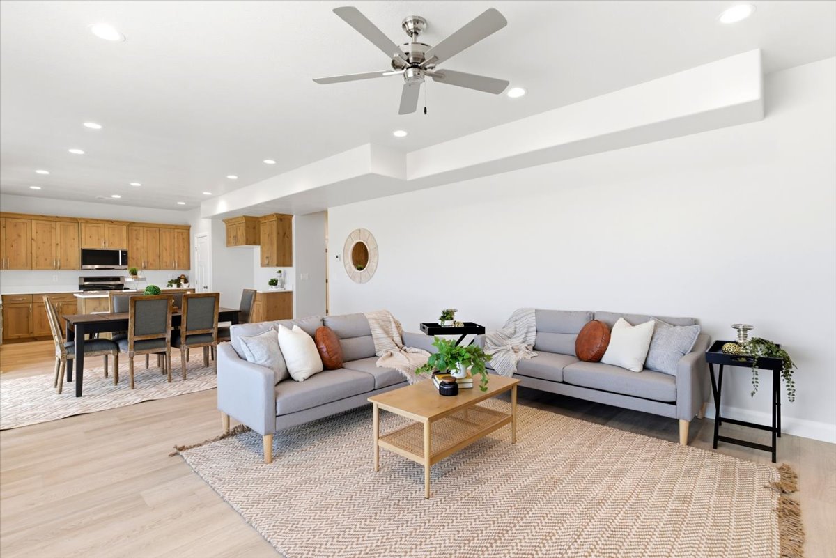 Open concept living space featuring wood-finish flooring and recessed lighting