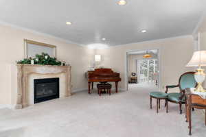 Formal living area featuring a decorative stone fireplace with a black insert