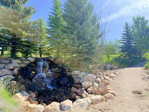 Community water feature at entrance with walking path