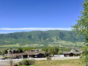 West View from Deck. Expansive mountain landscape with tree-covered slopes