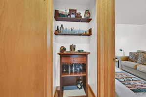 Recessed nook featuring built-in shelving and a dedicated space for a console table