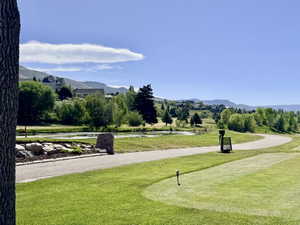Wolf Creek golf course green with a cart path and a water feature. Walking distance.