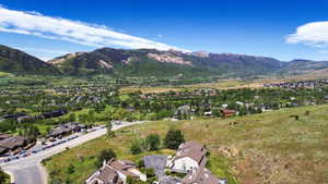 Expansive valley landscape with distant mountainous terrain under a clear blue sky
