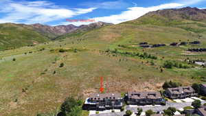 Townhome property with multi-level architecture and a prominent mountain backdrop