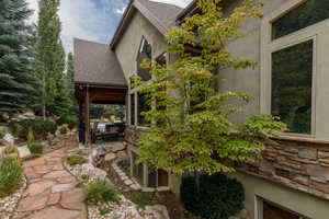 Exterior featuring stone cladding accents and large picture windows