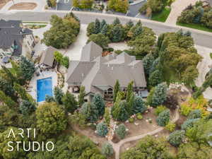 Expansive property featuring a multi-level residence with a gray shingle roof and multiple gables