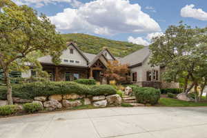 Stone and stucco exterior with multiple gables and dark wood accents