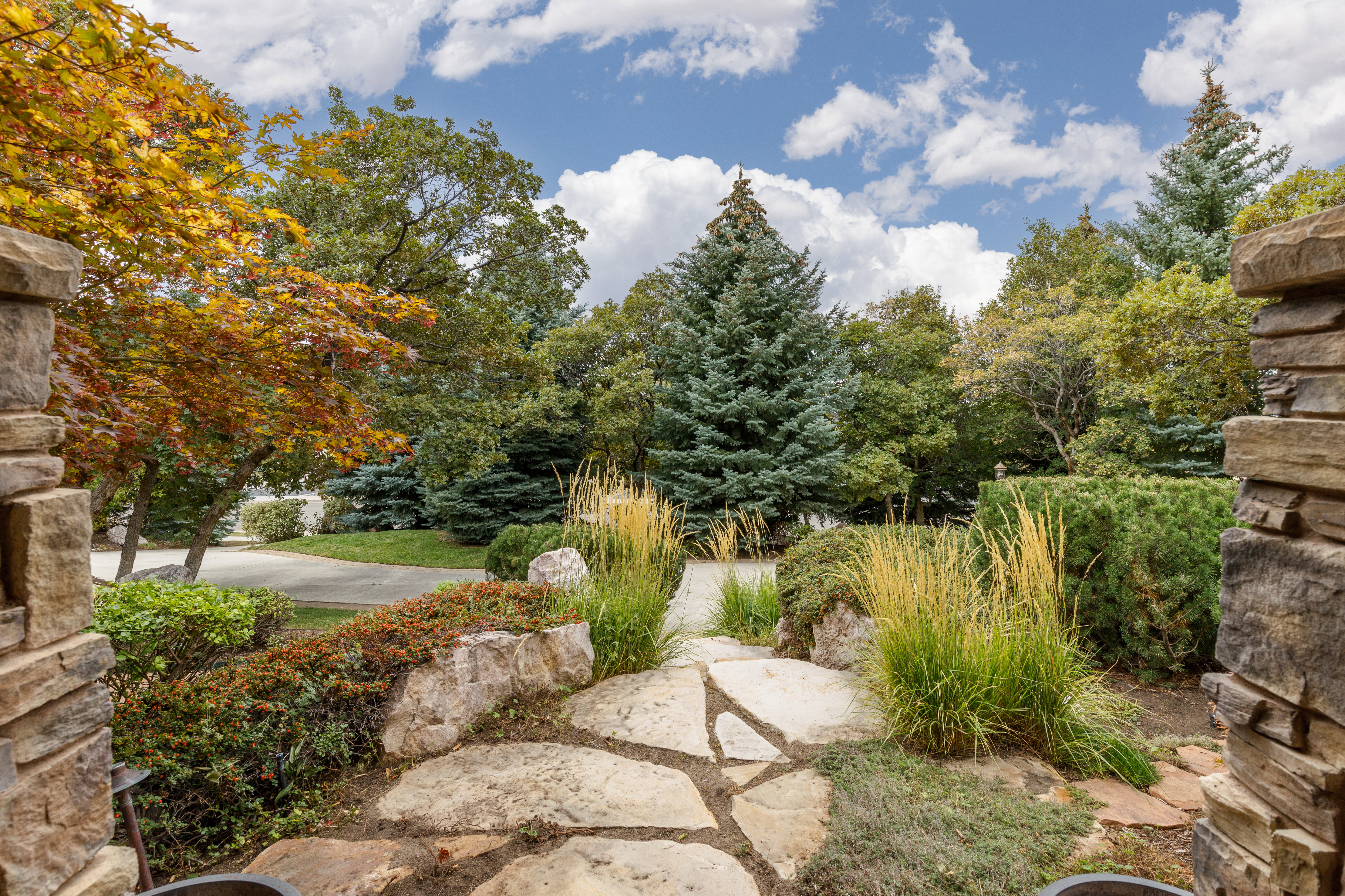 Stone pathway featuring natural flagstone and decorative grasses