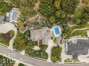 Extensive property featuring a large home with a multi-gabled roof, an in-ground swimming pool, a meandering driveway, and mature landscaping