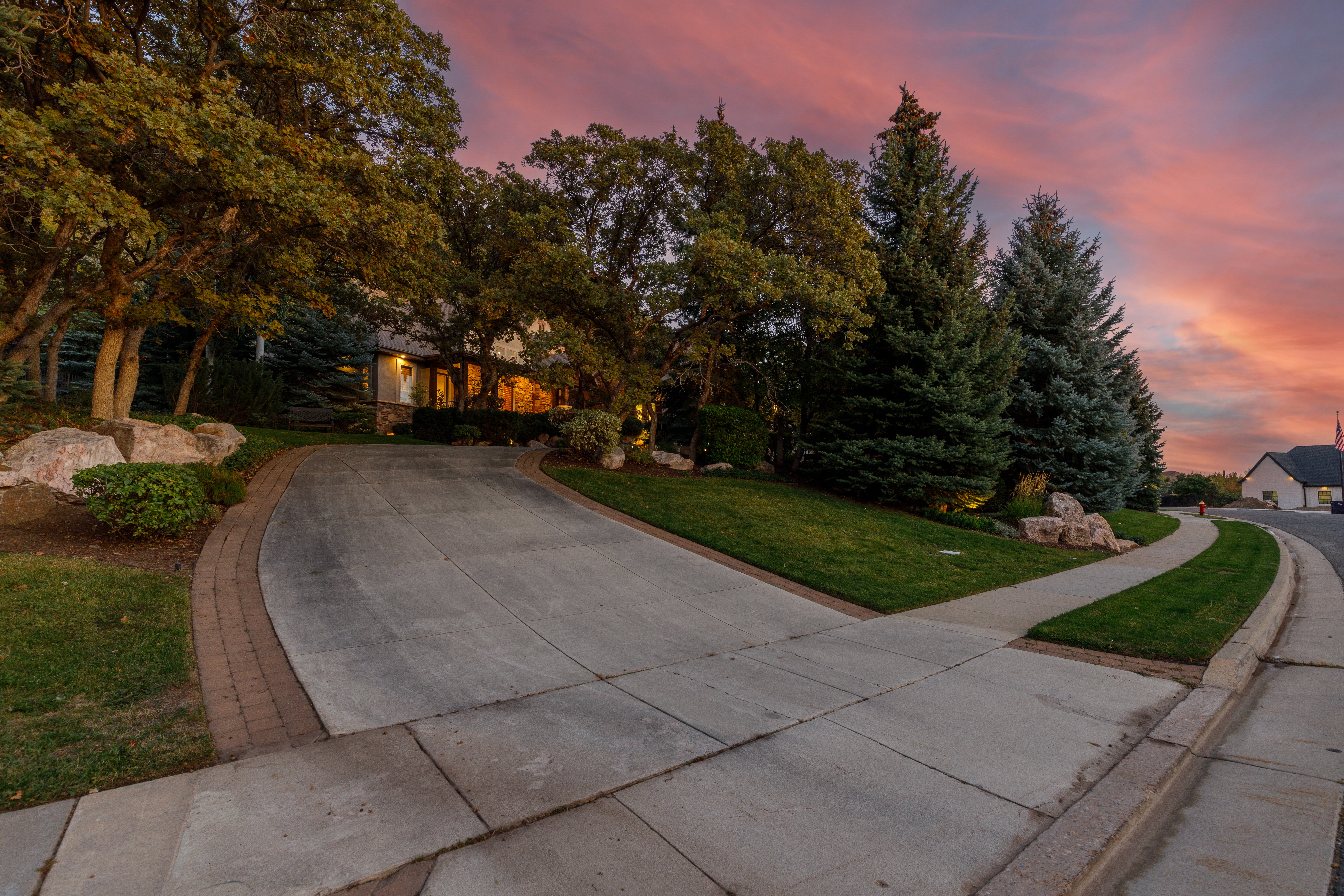 Curved concrete driveway with brick paver edging