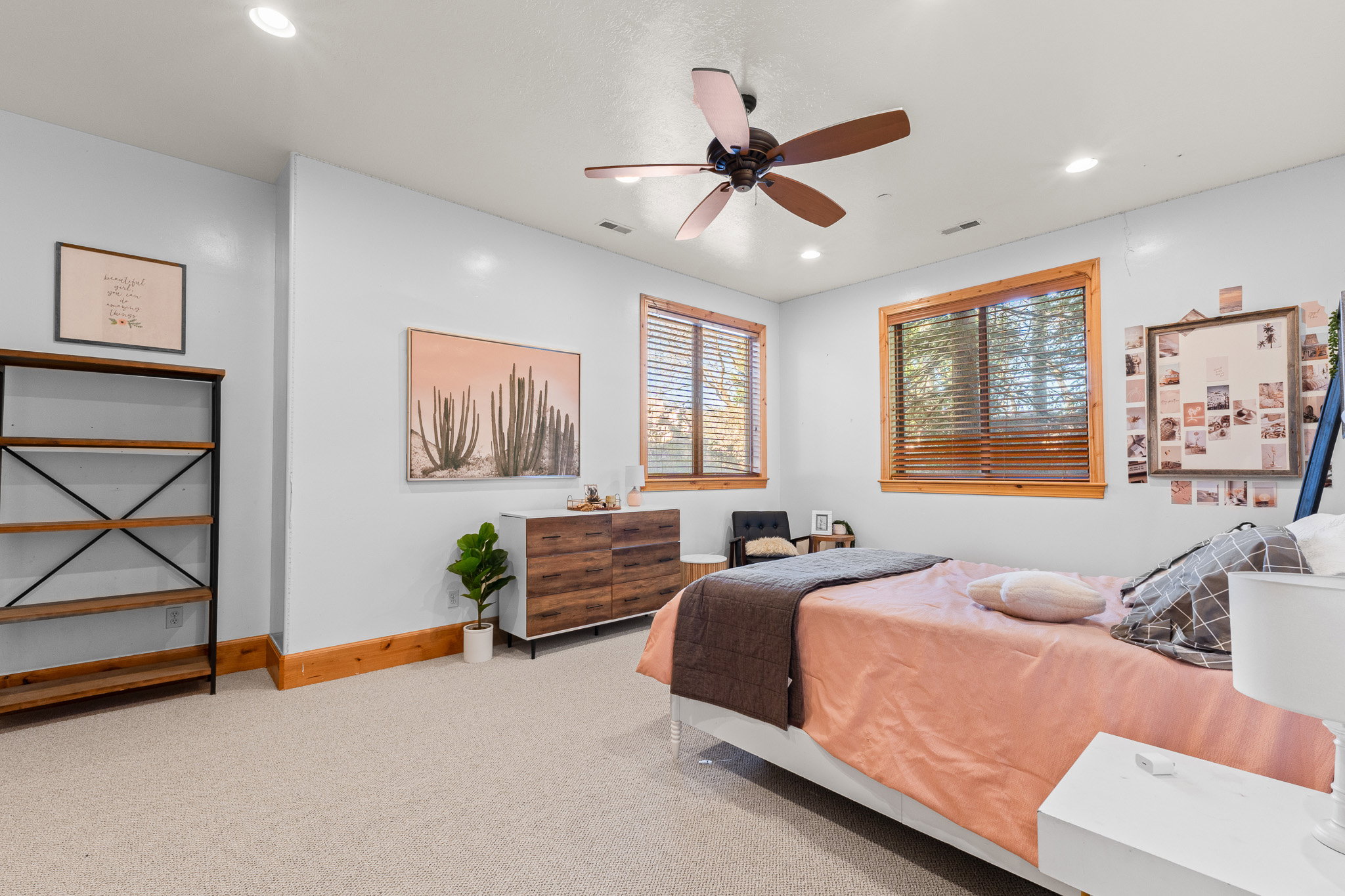 Carpeted room featuring two windows with wood frames, a ceiling fan, and recessed lighting