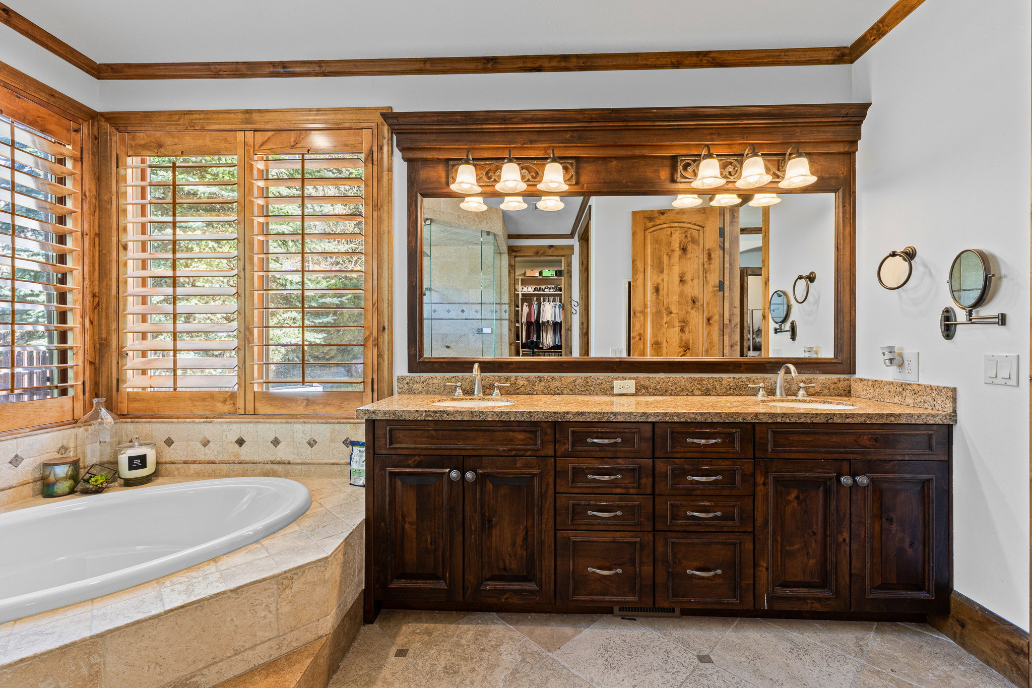 Dual vanity with wood-finish cabinetry and light-toned countertops