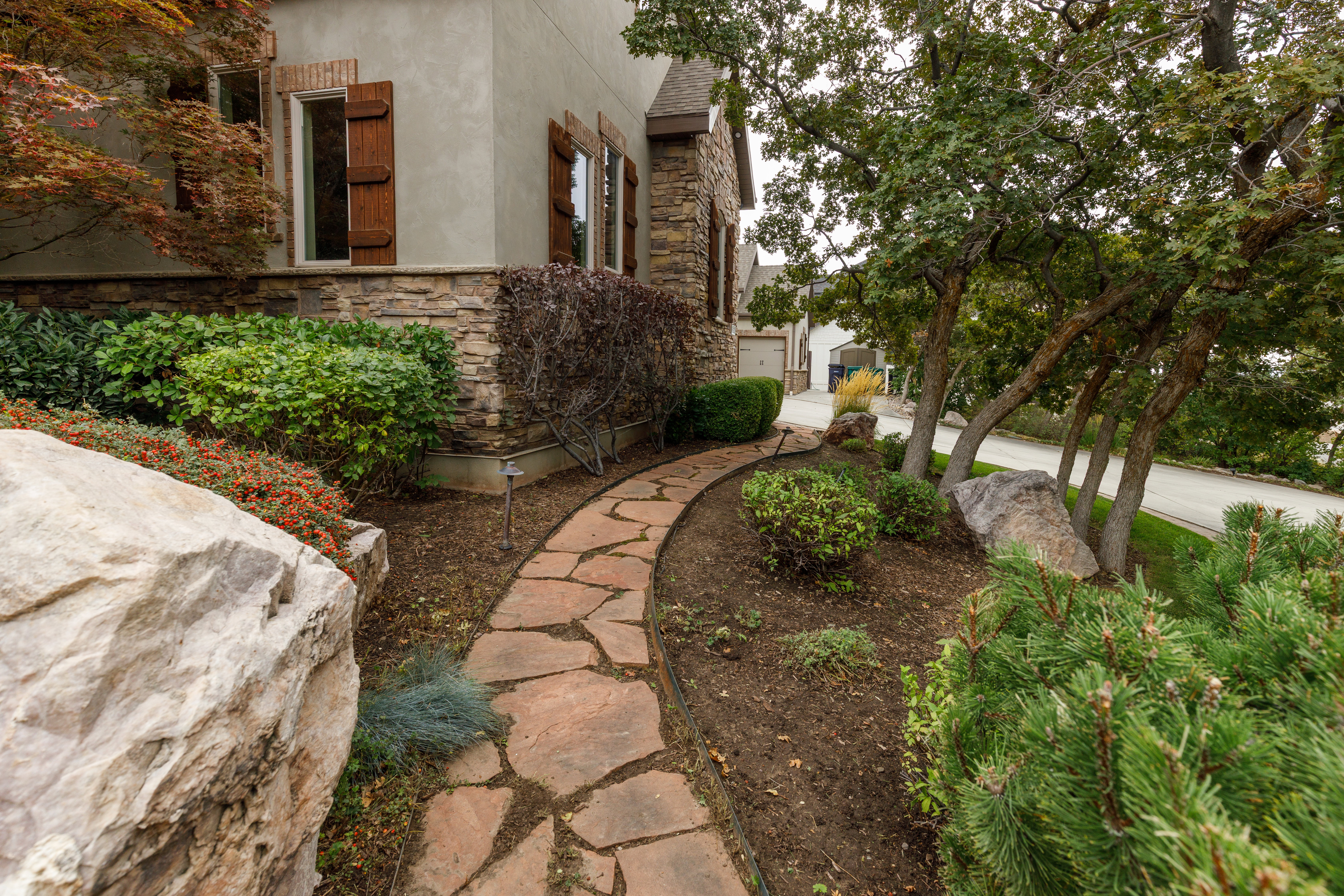 Stone pathway bordered by established landscaping