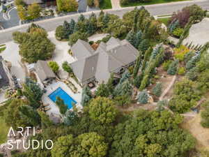 Expansive private grounds featuring a rectangular swimming pool, a separate pool house structure, and extensive mature landscaping with varied tree species