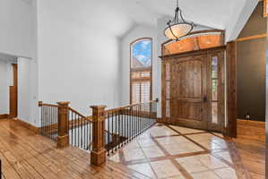 Grand entry featuring a solid wood door with decorative glass sidelights and an arched transom window
