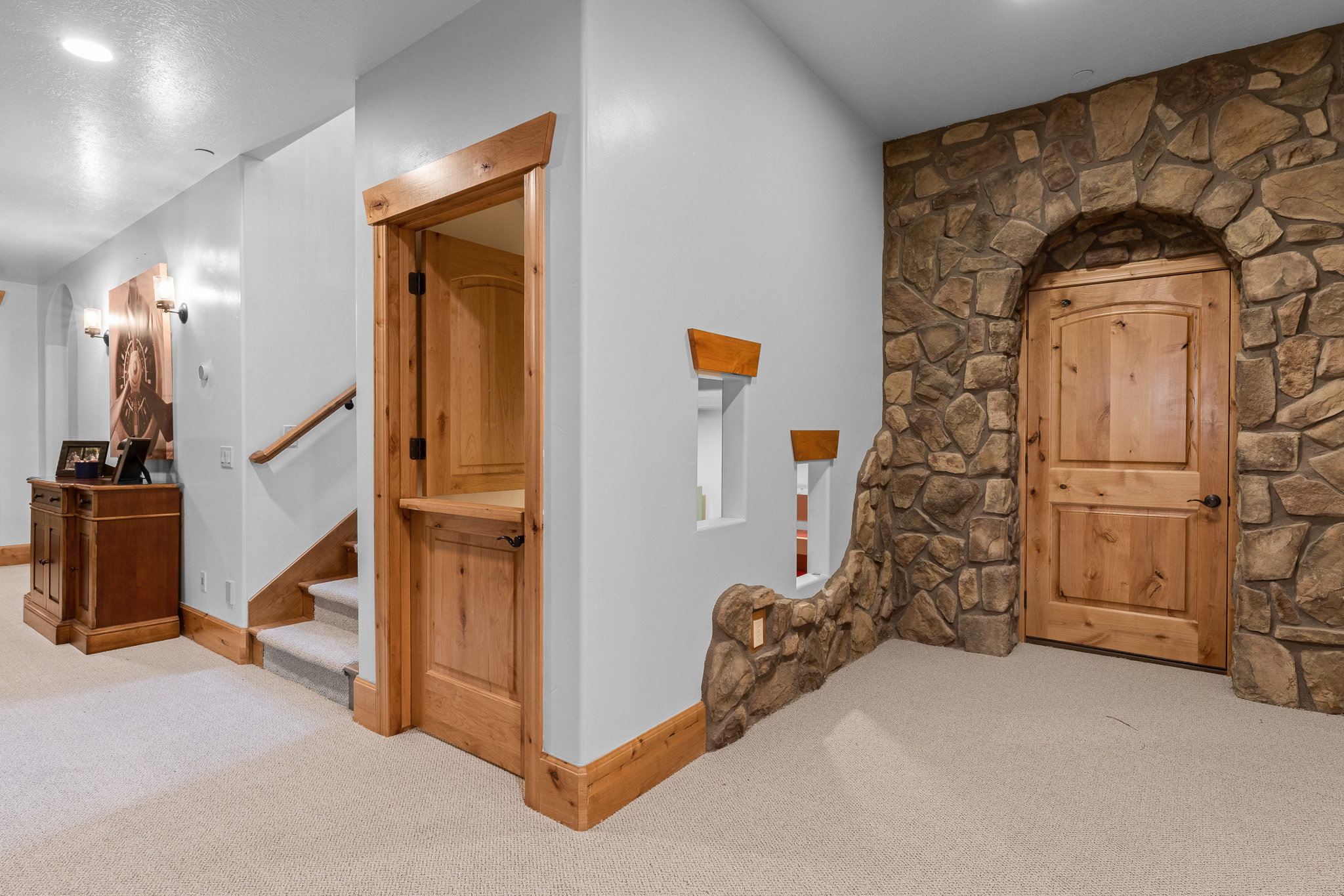 Stone archway entry featuring a paneled wood door