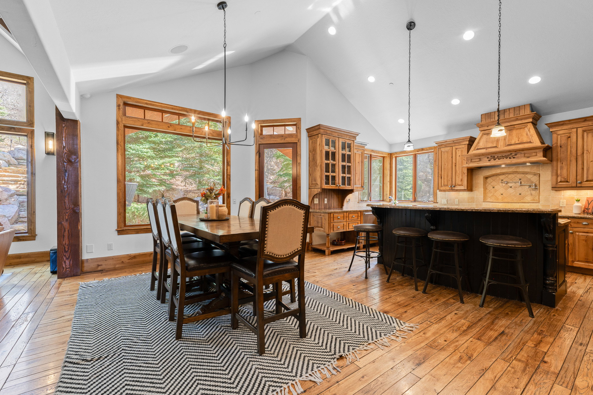 Vaulted ceilings complement wood-finish flooring throughout this open-concept space