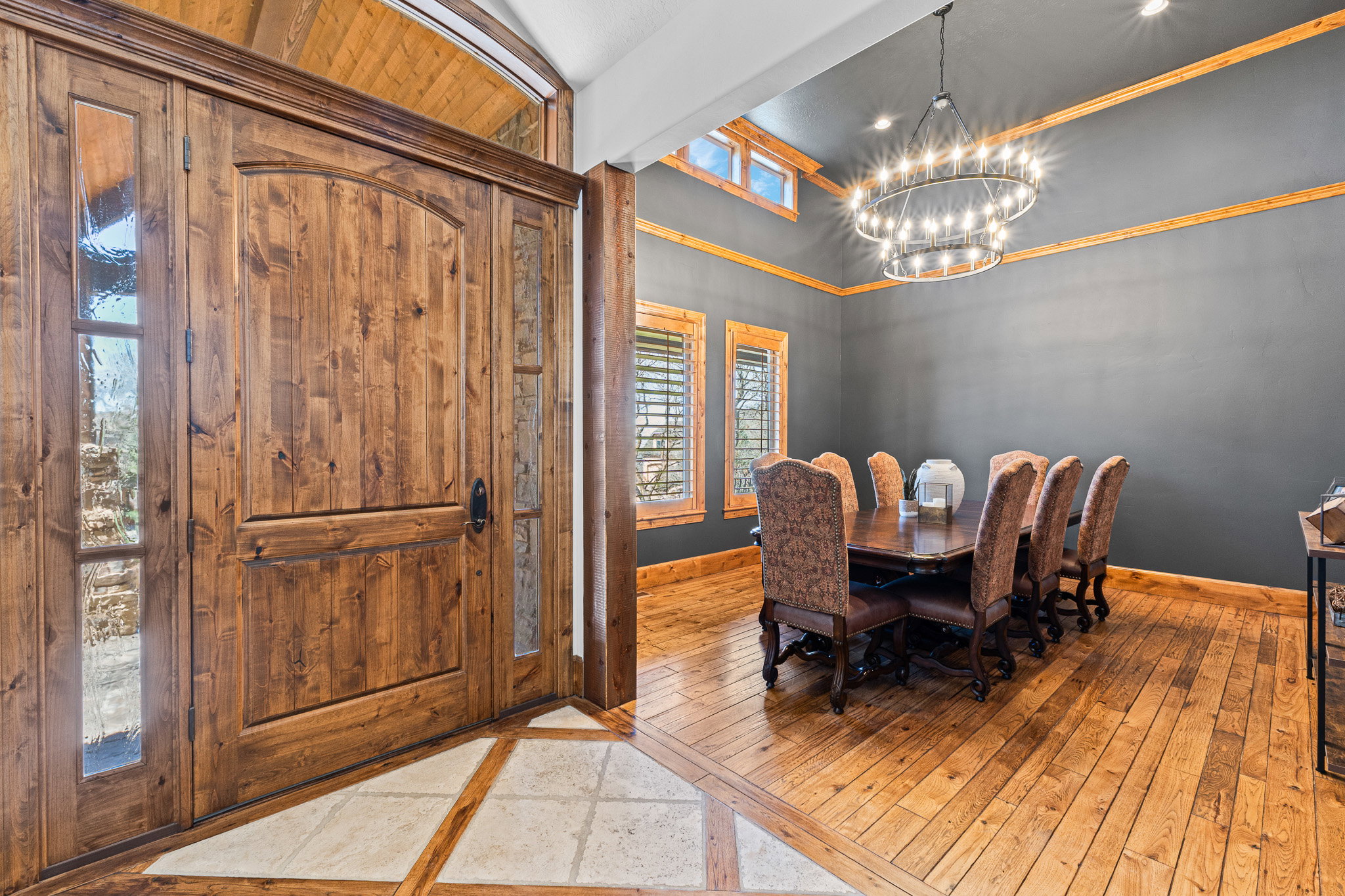 Grand wooden entry door with decorative glass sidelights