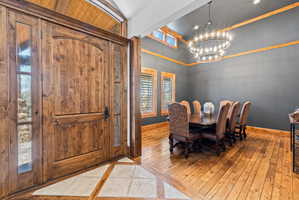 Grand wooden entry door with decorative glass sidelights