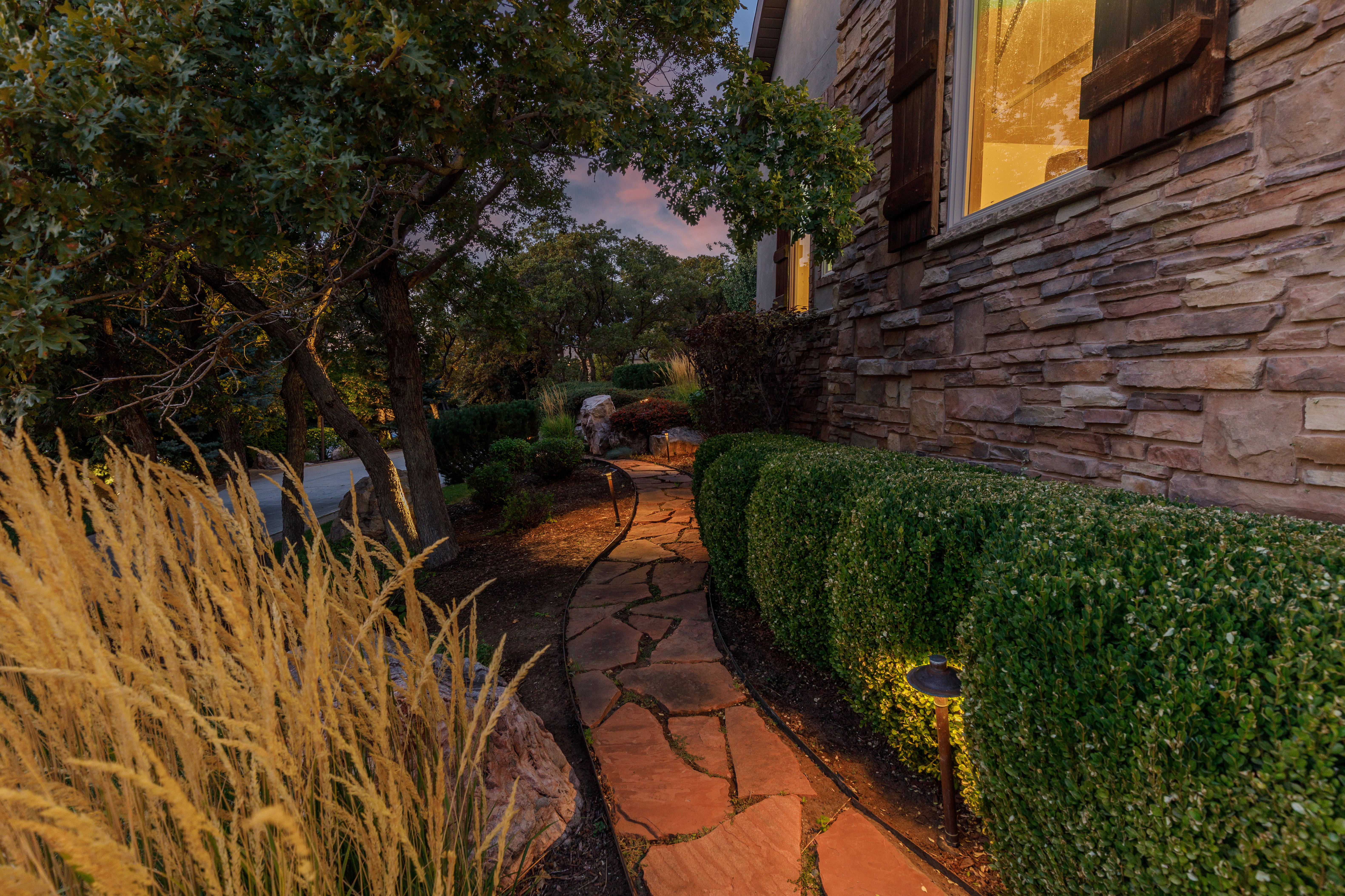 Stone veneer exterior with decorative window shutters