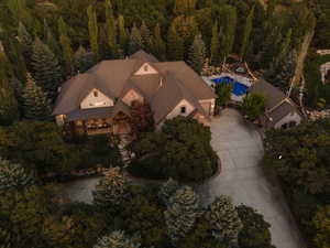 Expansive property featuring a large residence, a separate structure, and a swimming pool