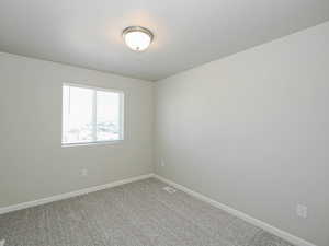 Neutral-toned walls complement the gray carpeting
