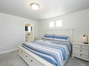 Carpeted bedroom with a built-in bed frame and headboard
