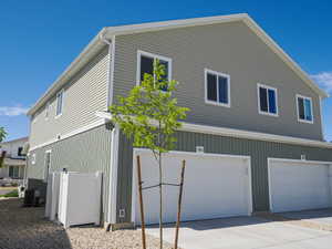 Two-story exterior with light green and dark green siding, white trim, and white frame windows