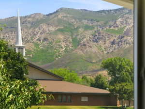 Mountain backdrop featuring rugged terrain and varied green foliage