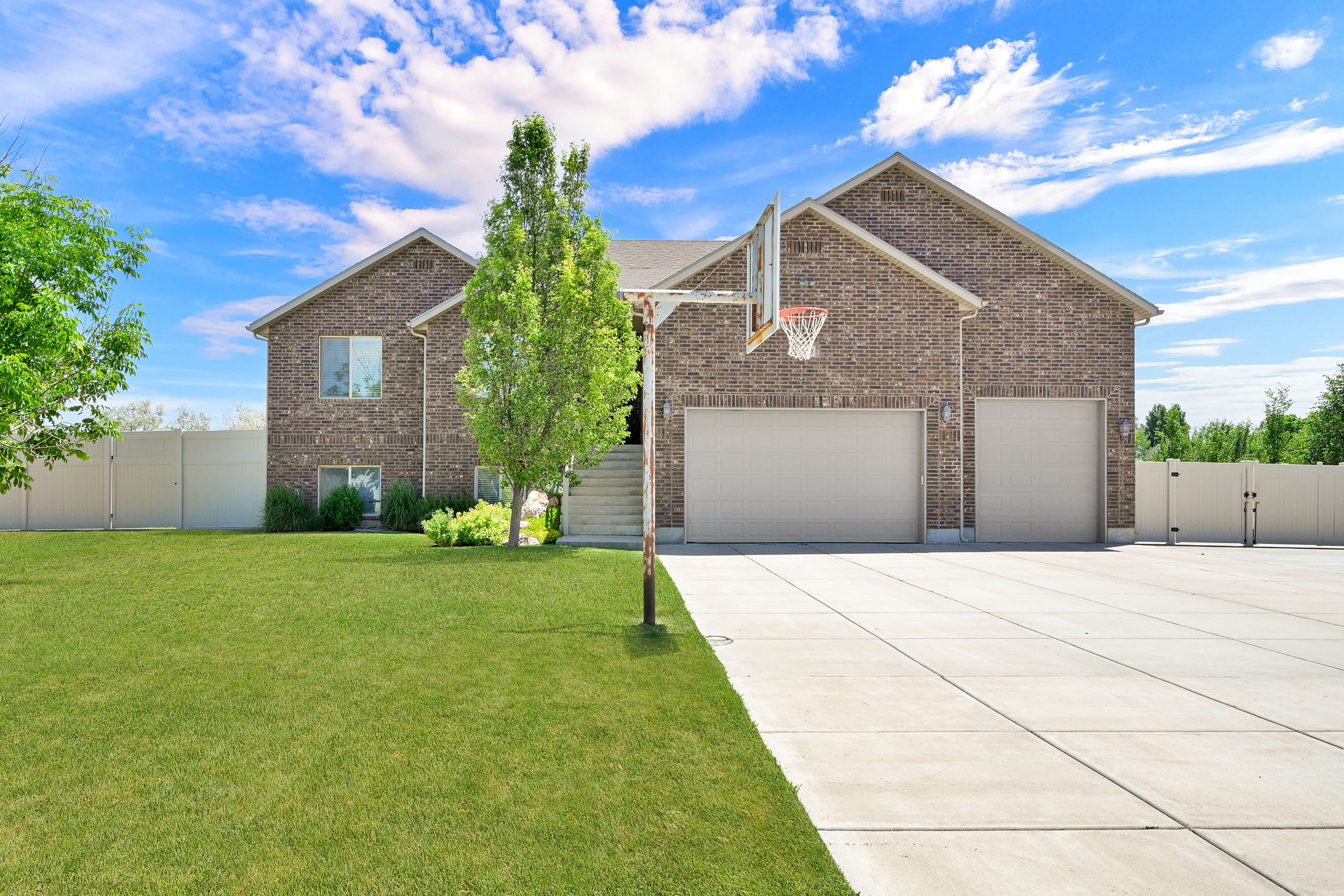Brick exterior residence featuring a two-car garage and an additional single-car garage