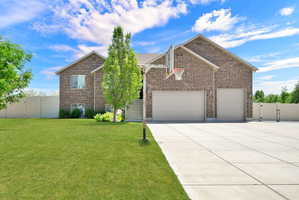 Brick exterior residence featuring a two-car garage and an additional single-car garage