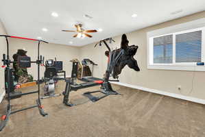 Spacious room with recessed lighting and a ceiling fan