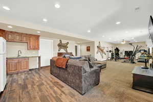 Spacious lower level featuring a wet bar with wood cabinetry and a undermount sink