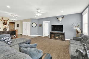 Spacious living area featuring neutral carpeting and light gray walls