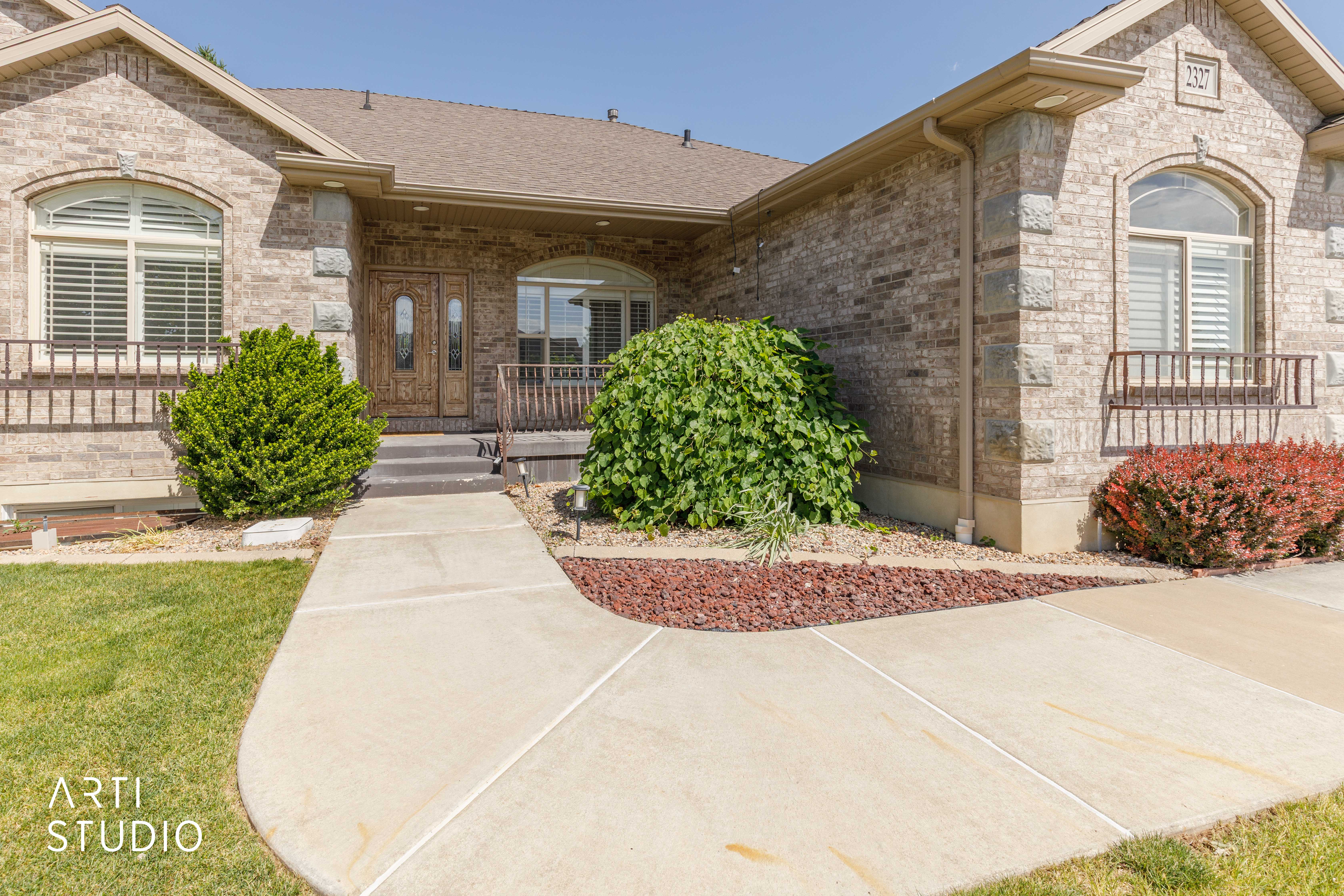 Brick exterior featuring stone accents and arched windows