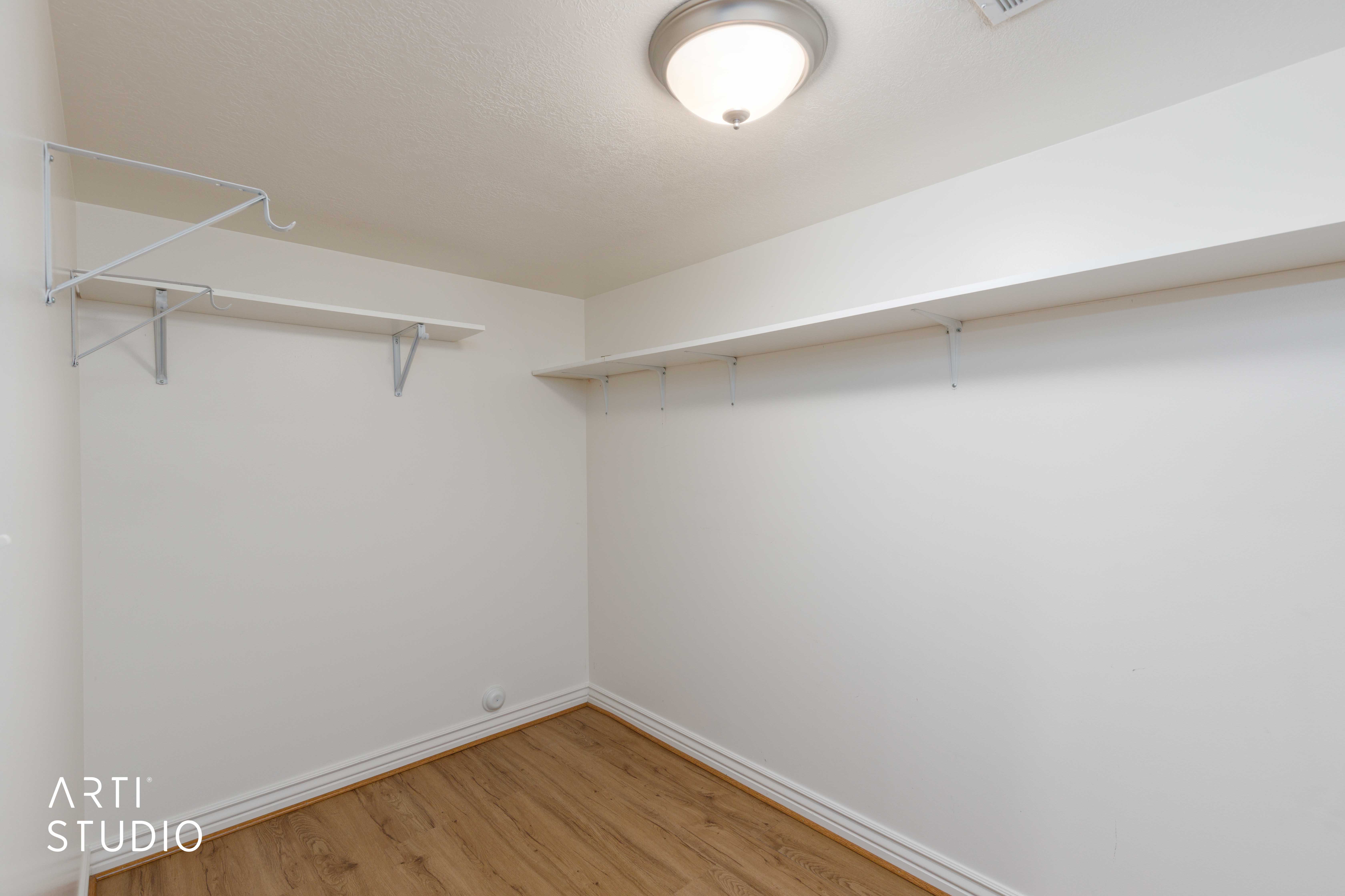 Interior space featuring wood-finish flooring, white baseboards, and light-colored walls