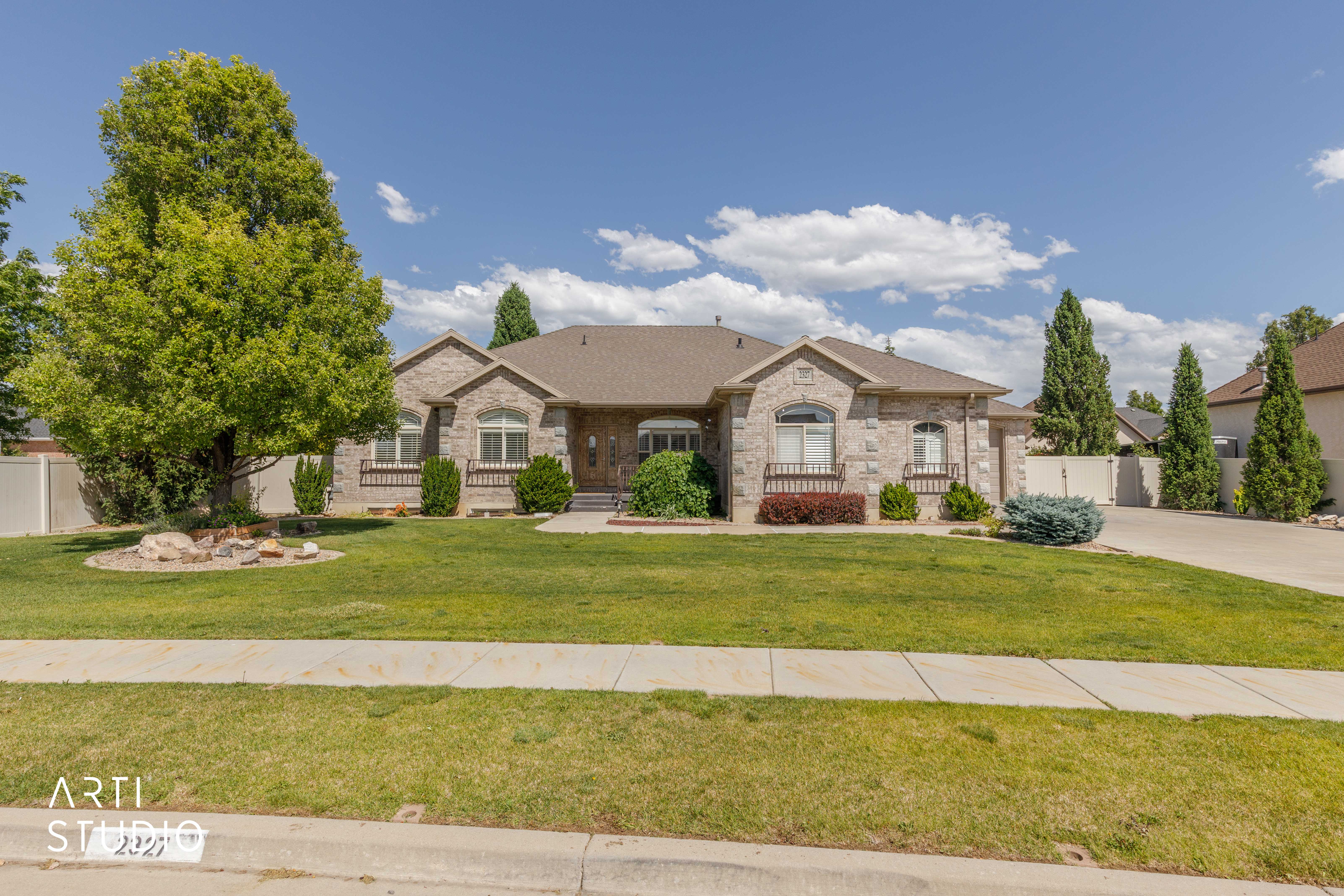 Stone veneer exterior featuring a gabled roof and arched windows