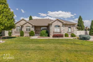 Stone veneer exterior with multiple arched windows, prominent gables, a dark shingle roof, and a maturely landscaped front yard with a paved driveway
