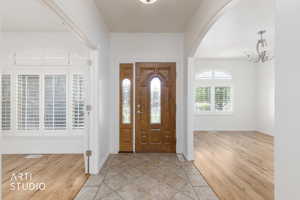 Double wooden entry doors with decorative glass inserts
