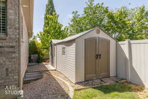Outdoor storage shed featuring double doors and a gable roof