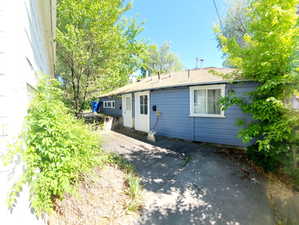 Exterior property featuring blue horizontal siding and a light-colored roof