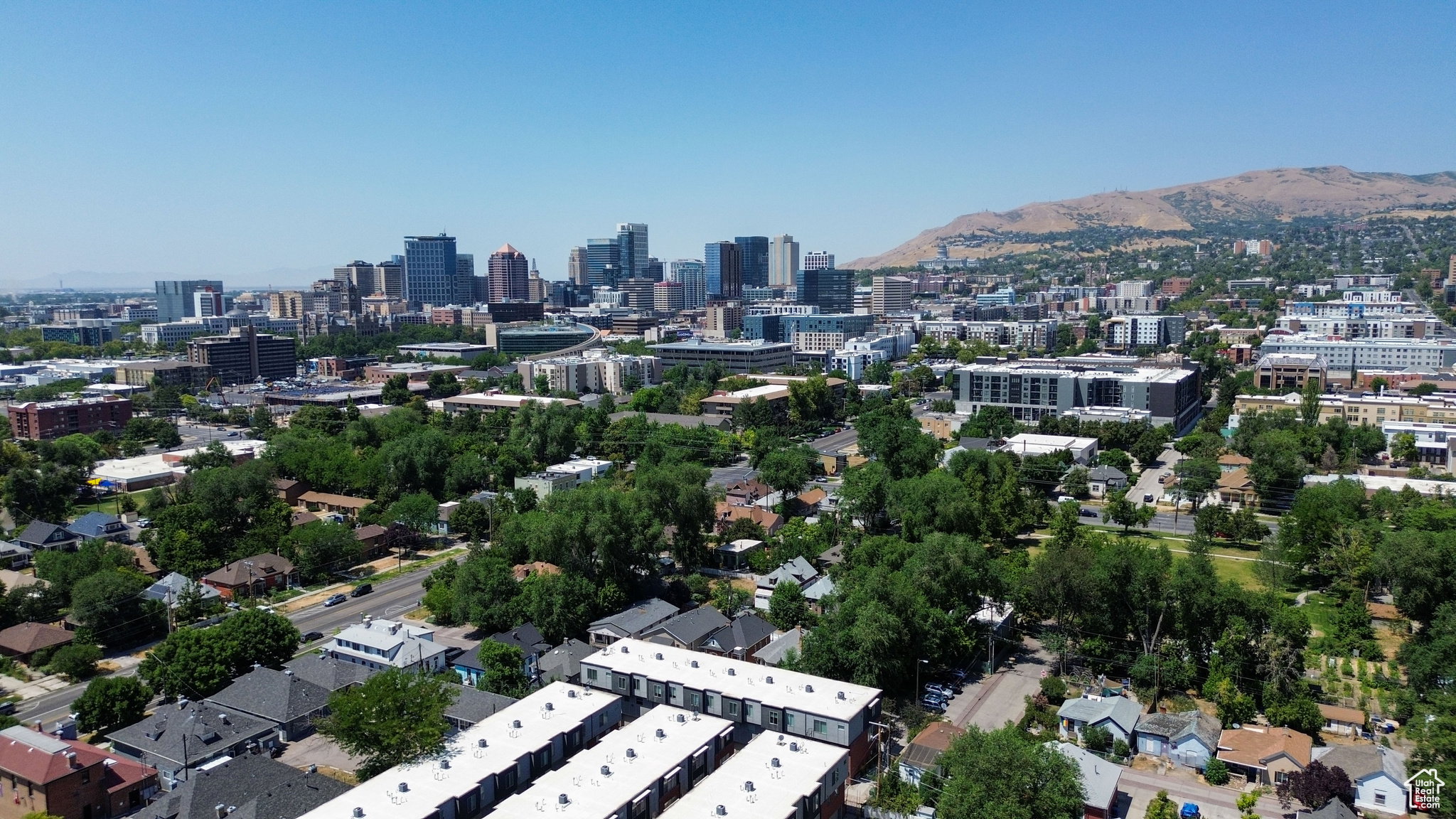 Elevated perspective showcasing a mixed-use urban landscape with a distant mountain backdrop