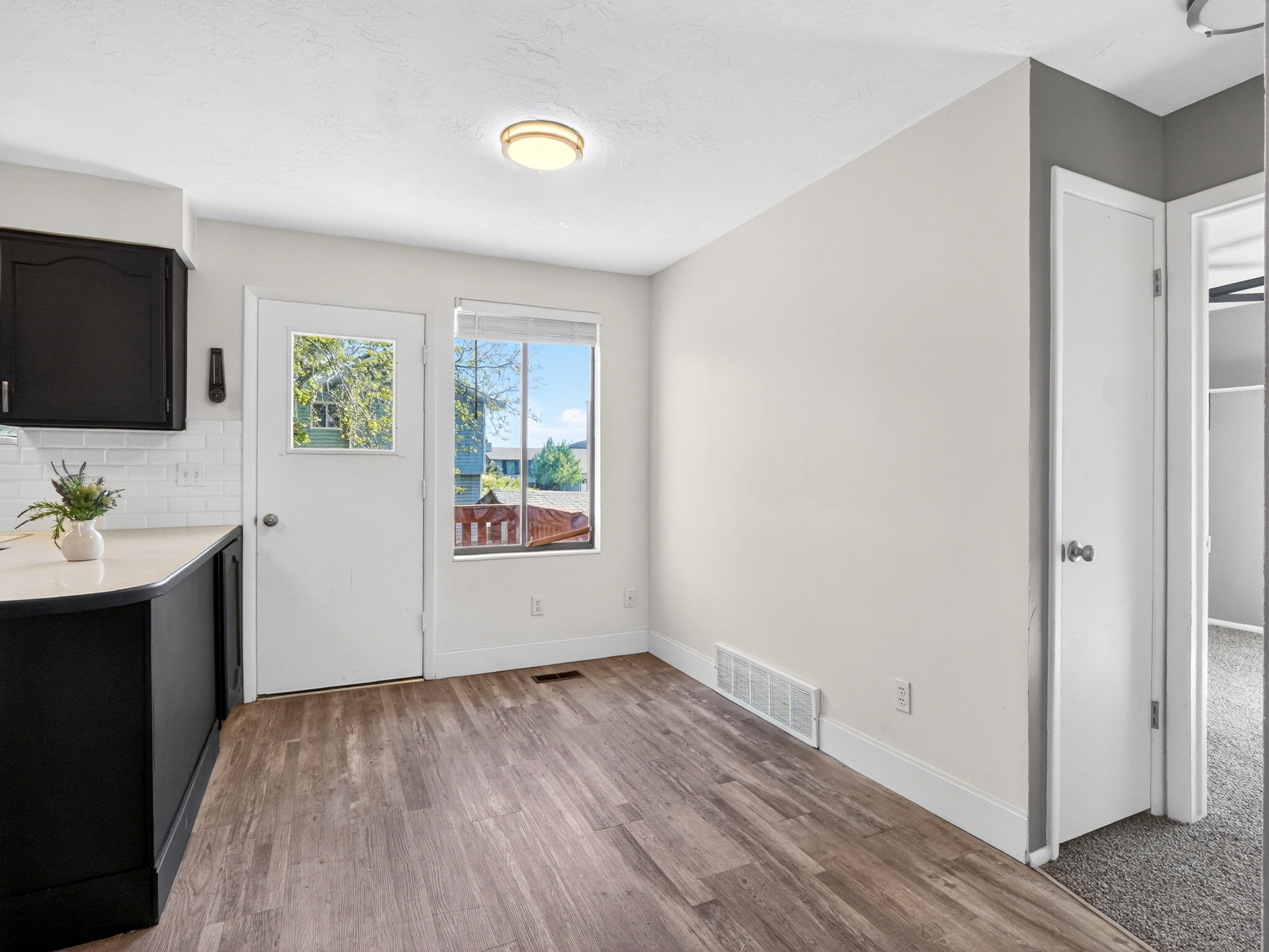 Kitchenette space featuring wood-finish flooring, white walls, and a recessed ceiling light