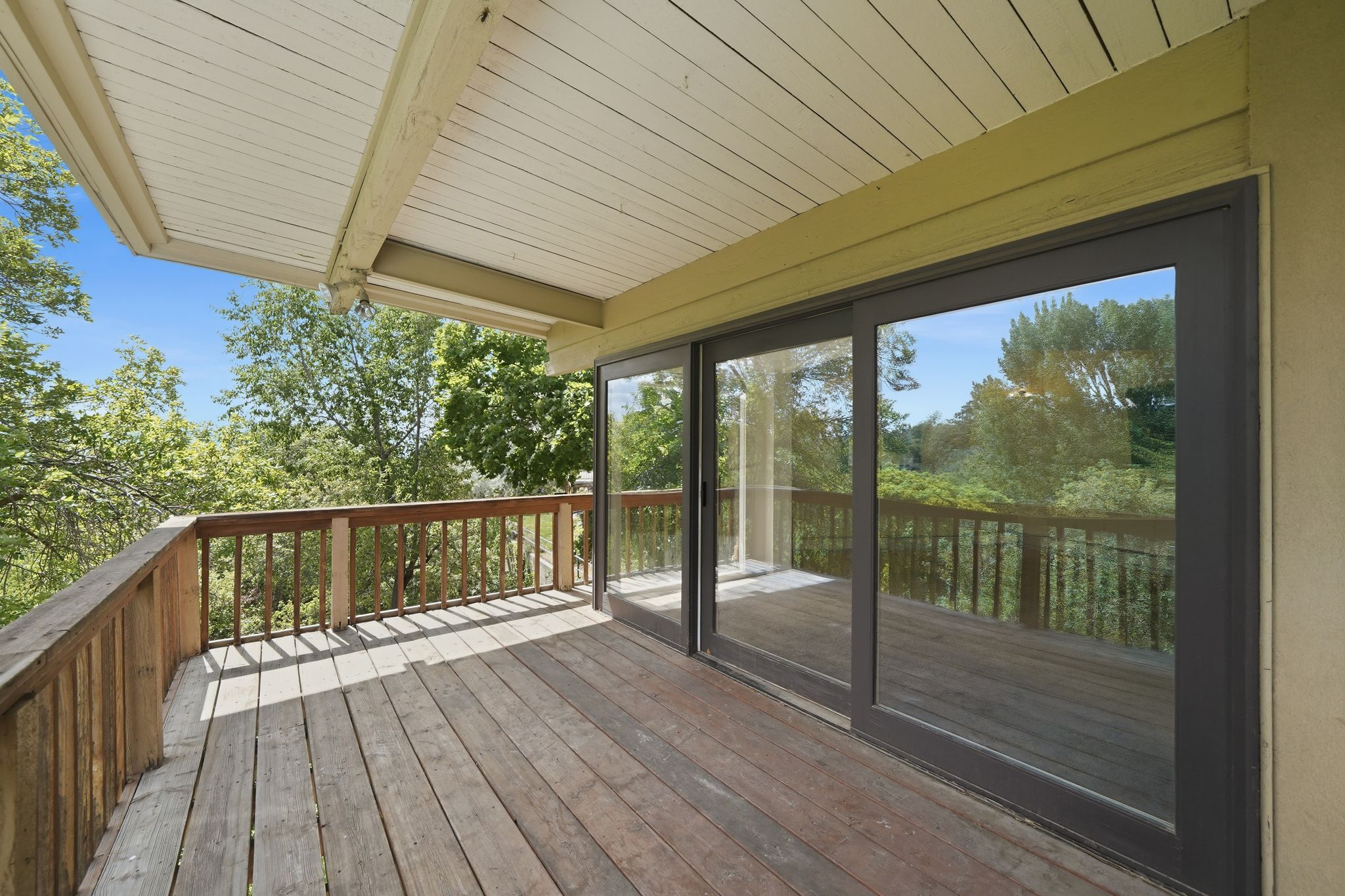 Expansive wood-plank deck with a perimeter wood railing
