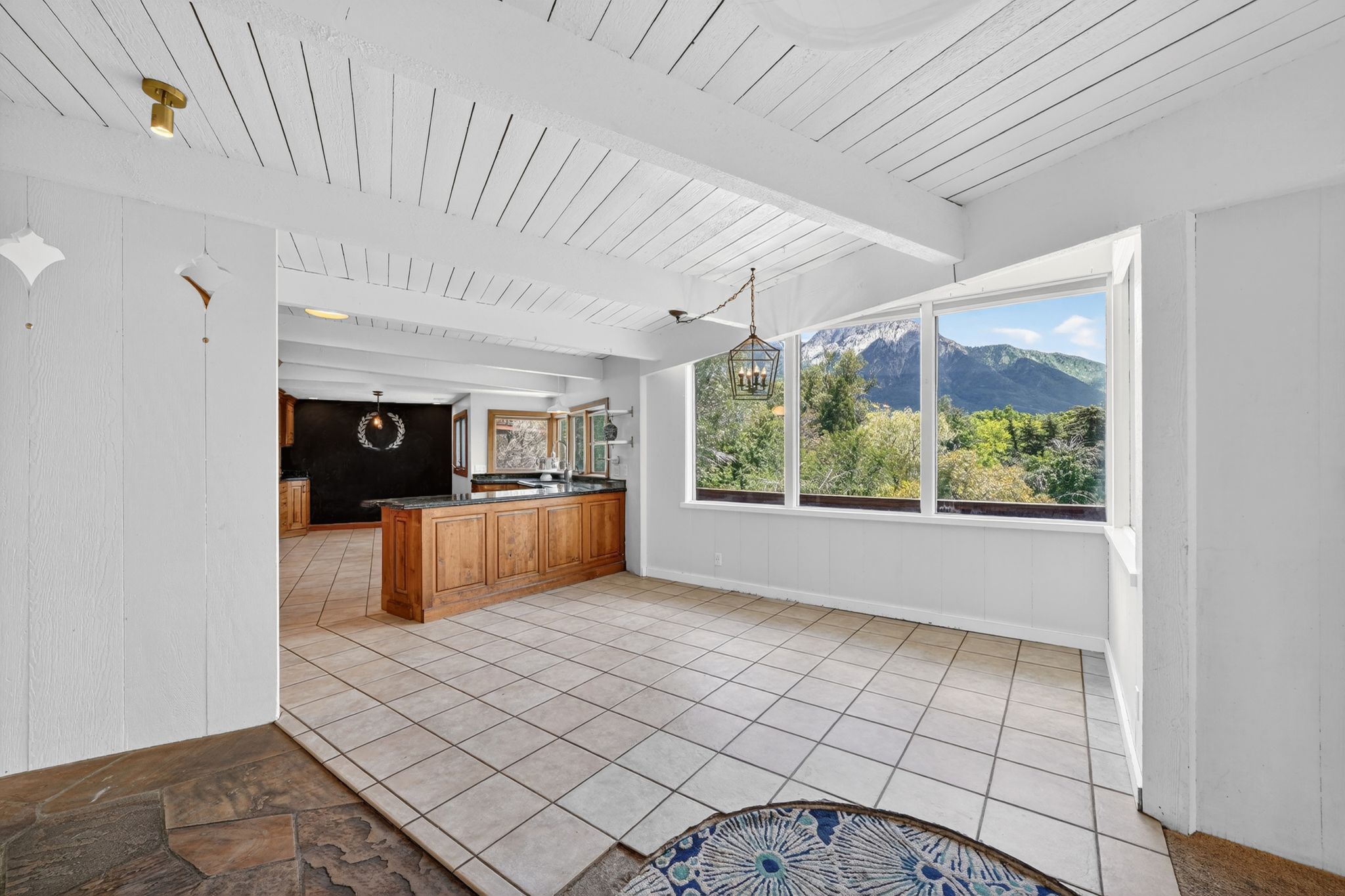Expansive windows frame panoramic mountain and tree scenery